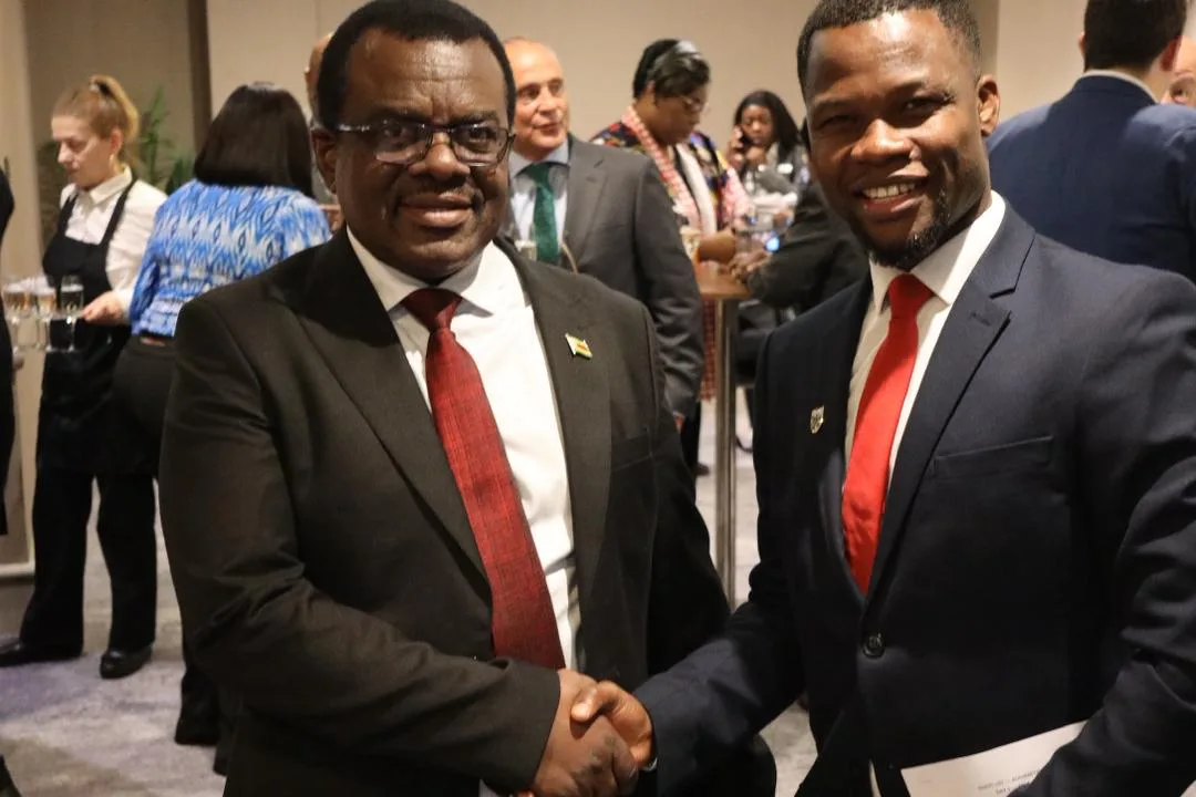 Abel Mavura shaking hands with a delegate at an African Leadership Organization reception