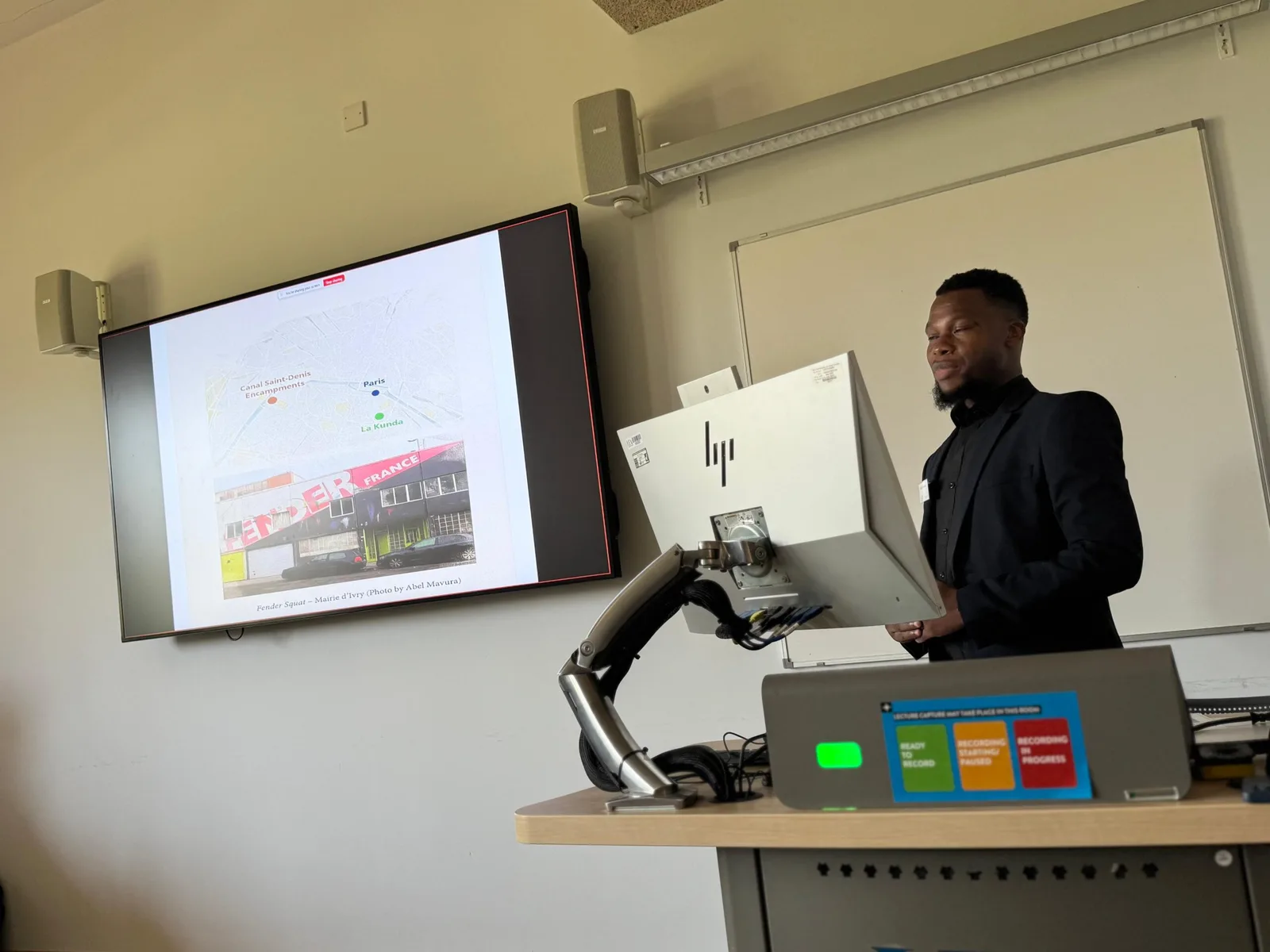 Abel Mavura presenting research slides at a seminar