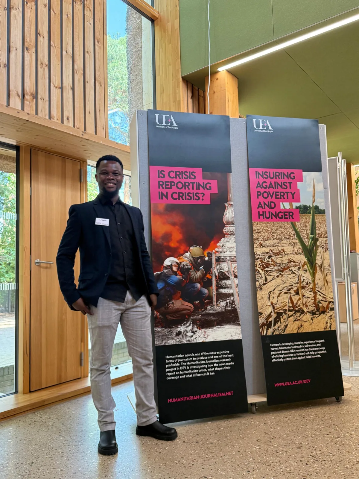 Abel Mavura beside a University of East Anglia research exhibition